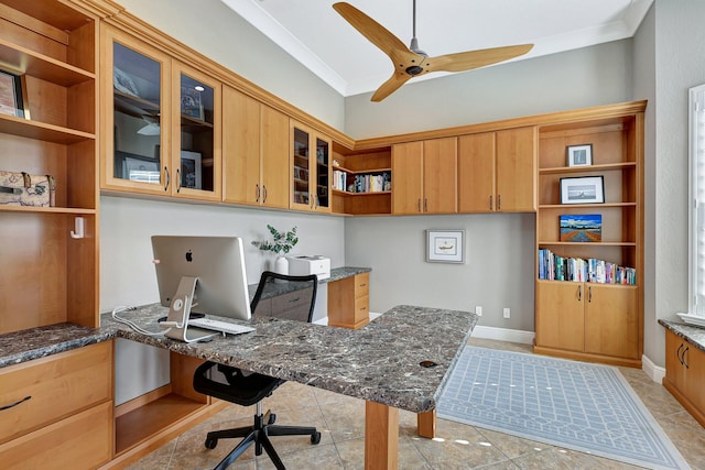 home office featuring built in desk, ceiling fan, ornamental molding, and light tile patterned flooring