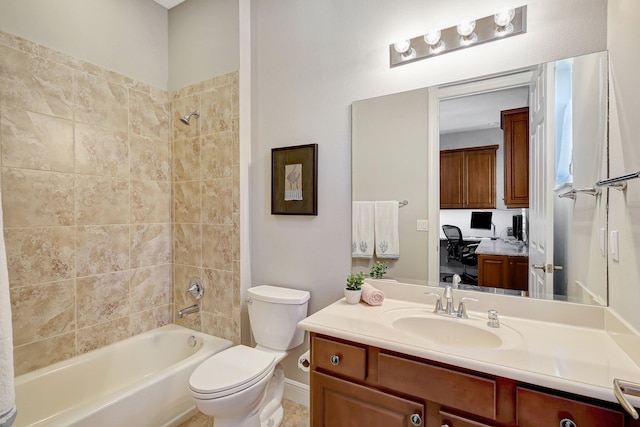 full bathroom with toilet, vanity, and tiled shower / bath