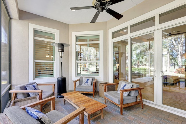 sunroom featuring a wealth of natural light and ceiling fan