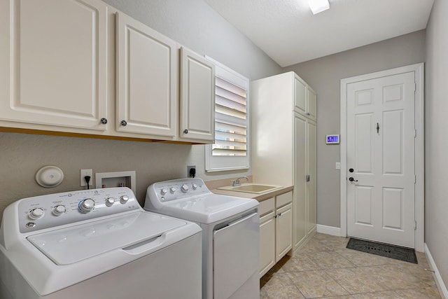 laundry room with washing machine and dryer, sink, light tile patterned floors, and cabinets