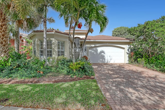 mediterranean / spanish house with a garage