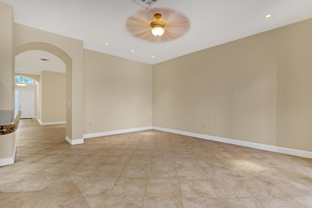 spare room featuring light tile patterned floors and ceiling fan