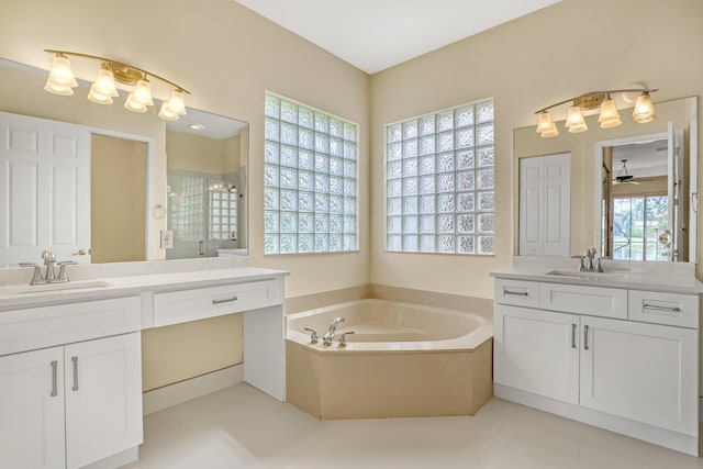 bathroom with ceiling fan, tile patterned flooring, vanity, and plus walk in shower