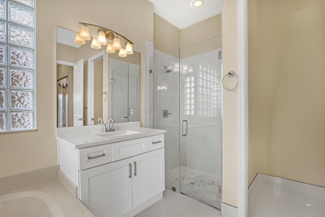 bathroom featuring vanity and a shower with shower door