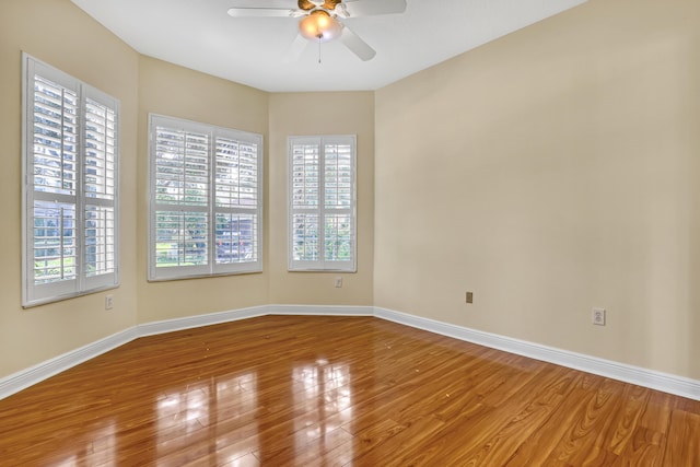 spare room with hardwood / wood-style floors and ceiling fan