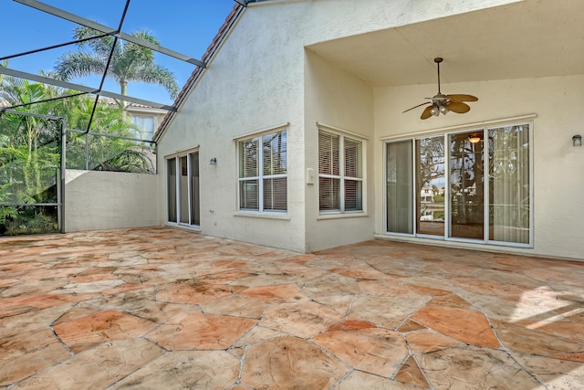 view of patio / terrace featuring glass enclosure and ceiling fan