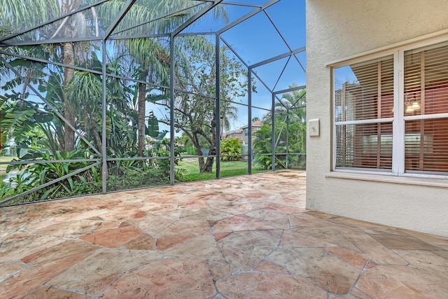 view of patio / terrace featuring glass enclosure