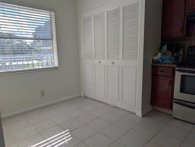 kitchen with white range with electric cooktop and light tile patterned floors