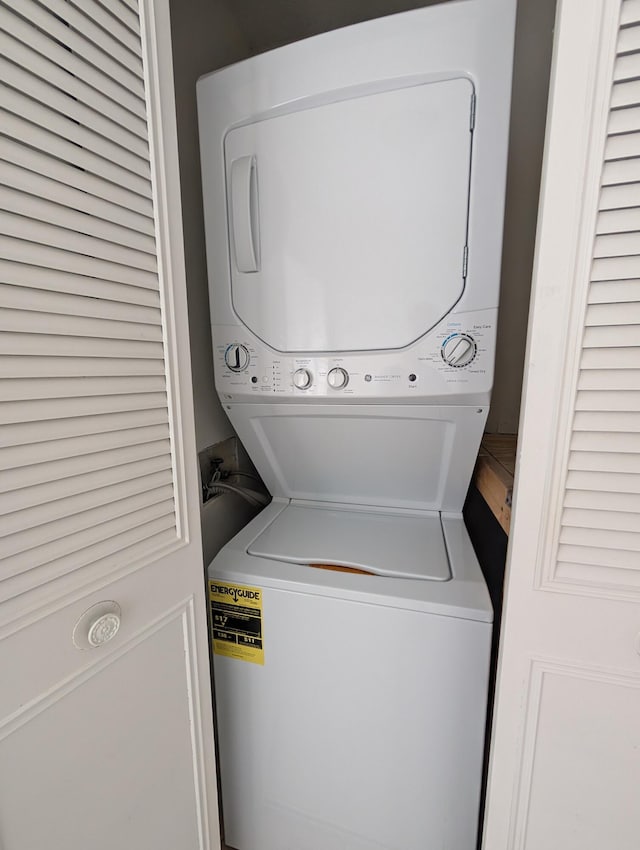 laundry area with stacked washing maching and dryer