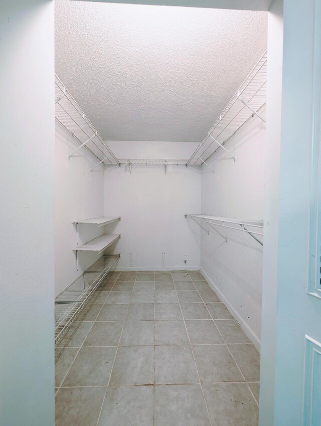 bathroom with tile patterned floors, vanity, toilet, and a shower with shower door