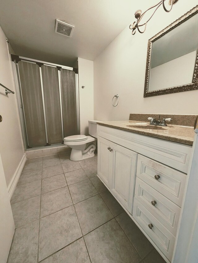 full bathroom with toilet, vanity, tile patterned floors, and tiled shower / bath combo