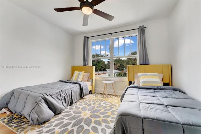 bedroom featuring hardwood / wood-style flooring, ceiling fan, and lofted ceiling