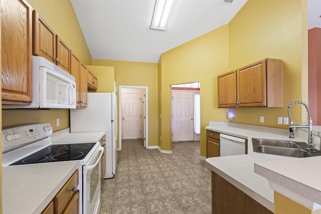 kitchen featuring white appliances, sink, and vaulted ceiling