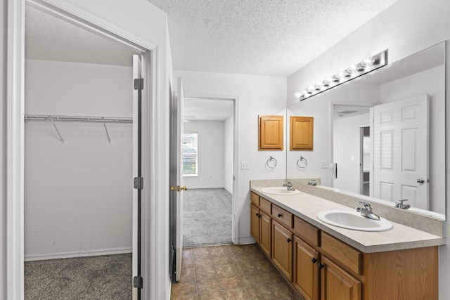 bathroom featuring vanity and a textured ceiling