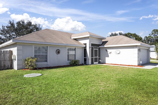 single story home with a garage and a front lawn