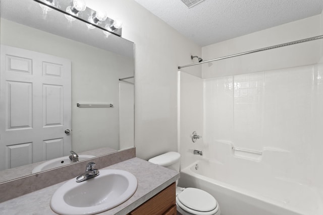 full bathroom featuring vanity, toilet, washtub / shower combination, and a textured ceiling