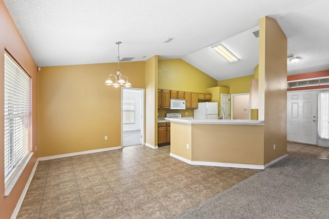 kitchen with pendant lighting, white appliances, vaulted ceiling, a notable chandelier, and kitchen peninsula