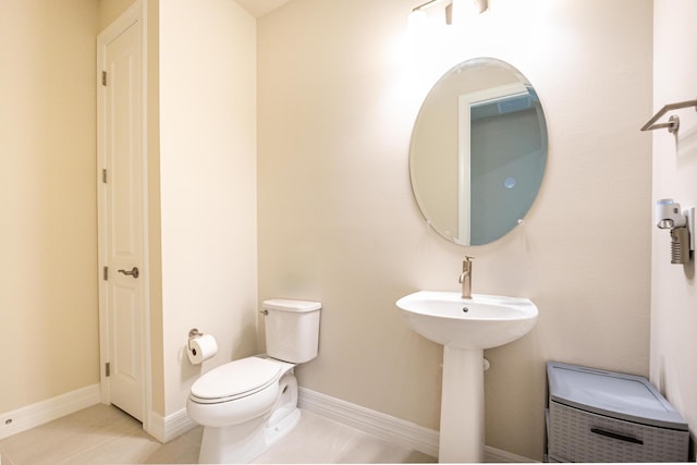 bathroom with tile patterned flooring and toilet