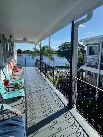 balcony featuring a water view