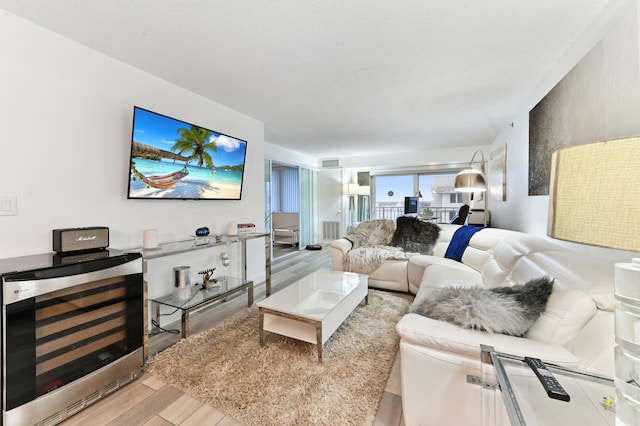 living room featuring beverage cooler and light hardwood / wood-style flooring