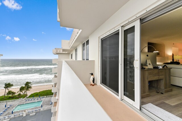 balcony featuring a view of the beach