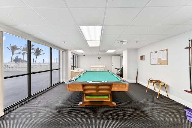 recreation room featuring dark colored carpet, a paneled ceiling, and billiards