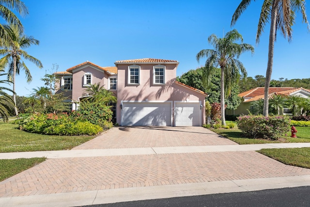 mediterranean / spanish-style house with a garage