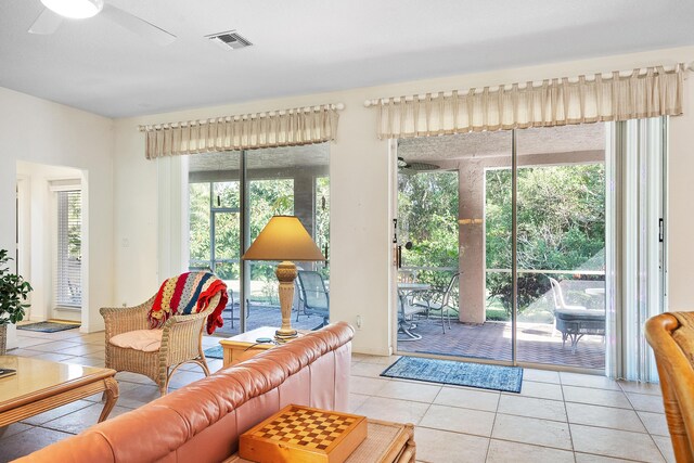 living room featuring ceiling fan and light tile patterned flooring