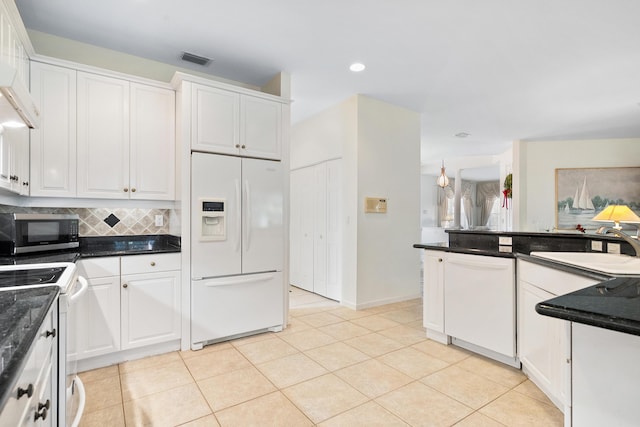 kitchen featuring white cabinetry, sink, and white appliances