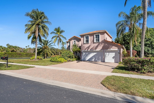 mediterranean / spanish house featuring a garage