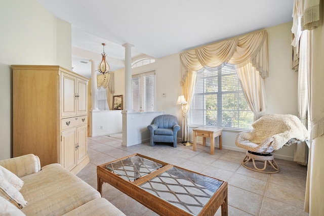 living area with light tile patterned floors and ornate columns