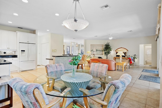 tiled dining area with ceiling fan