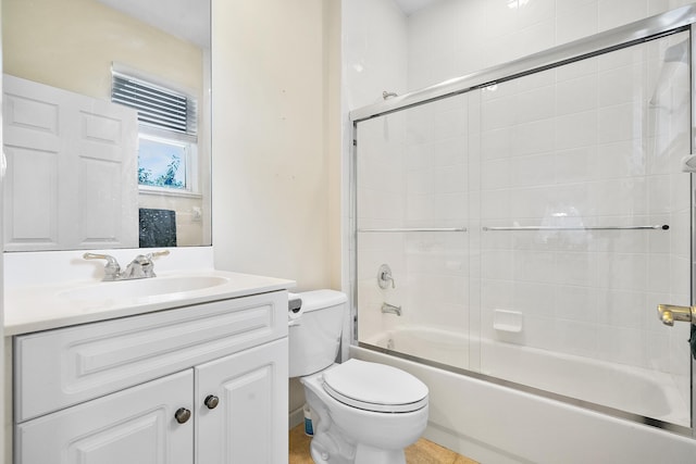 full bathroom with combined bath / shower with glass door, vanity, and toilet