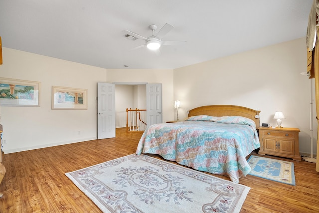 bedroom with ceiling fan and light hardwood / wood-style flooring