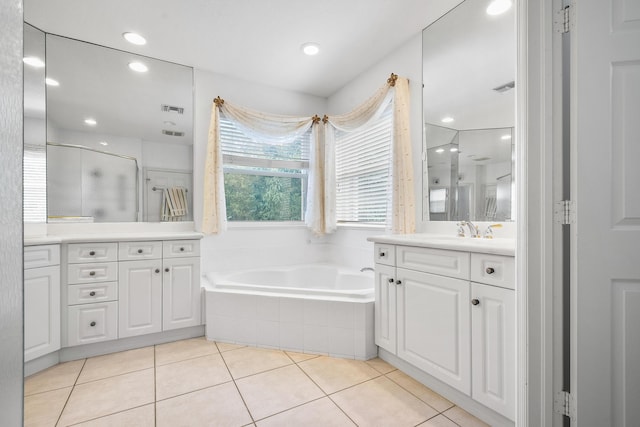 bathroom featuring tile patterned flooring, vanity, and separate shower and tub