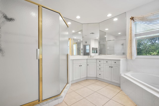 bathroom featuring tile patterned floors, vanity, and plus walk in shower