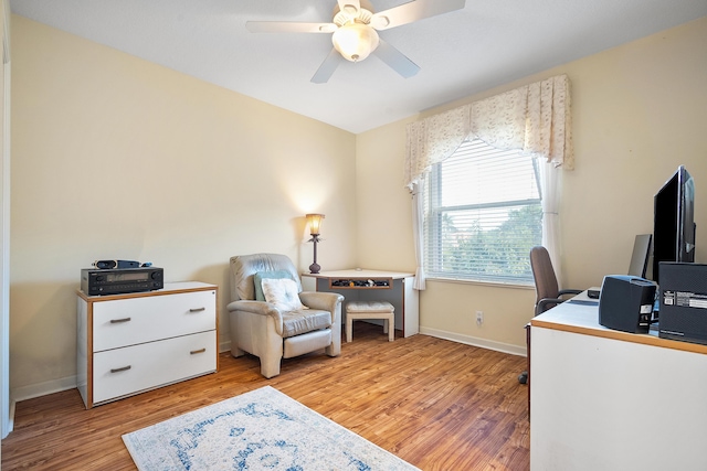 home office with ceiling fan and light hardwood / wood-style floors