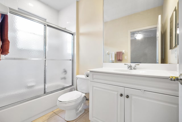 full bathroom featuring tile patterned flooring, vanity, toilet, and bath / shower combo with glass door