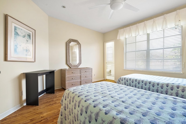 bedroom featuring hardwood / wood-style flooring, ensuite bath, and ceiling fan