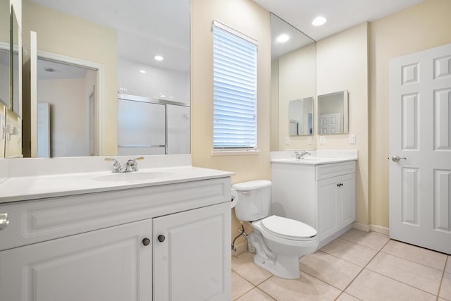 bathroom featuring toilet, tile patterned flooring, vanity, and walk in shower