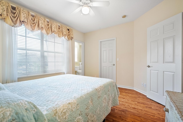 bedroom featuring hardwood / wood-style flooring, ceiling fan, and ensuite bathroom