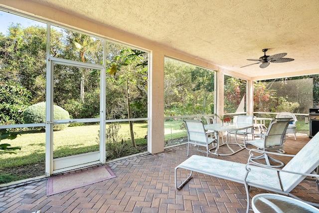 sunroom / solarium featuring ceiling fan