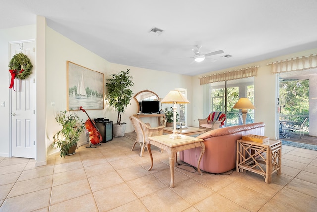 tiled living room featuring ceiling fan