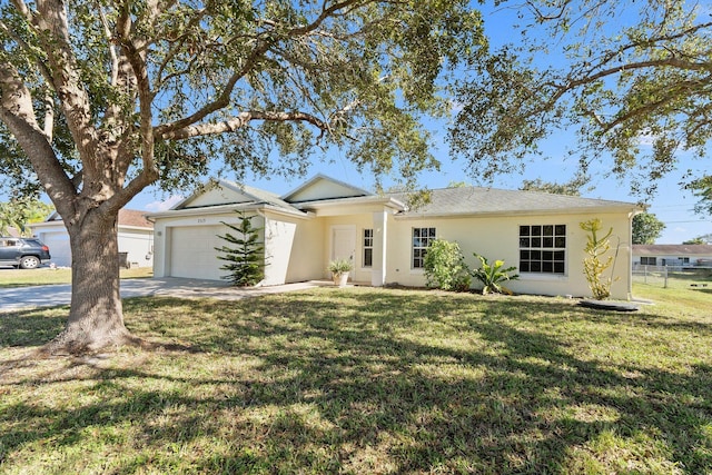 single story home featuring a front yard and a garage