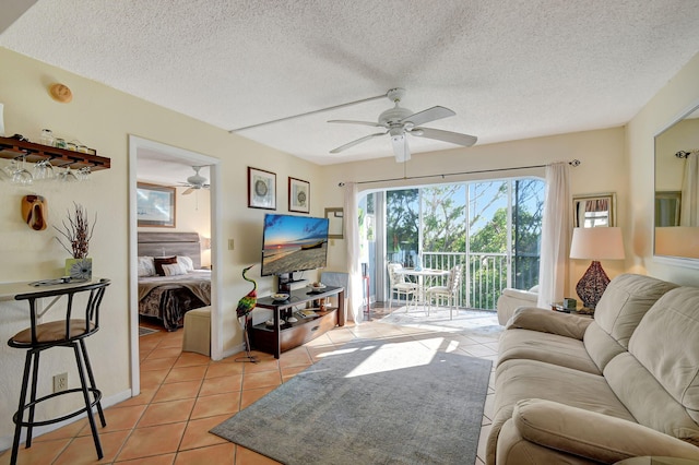 tiled living room with a textured ceiling and ceiling fan