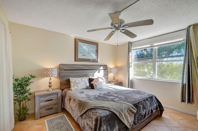 bedroom with a textured ceiling, ceiling fan, and light tile patterned flooring