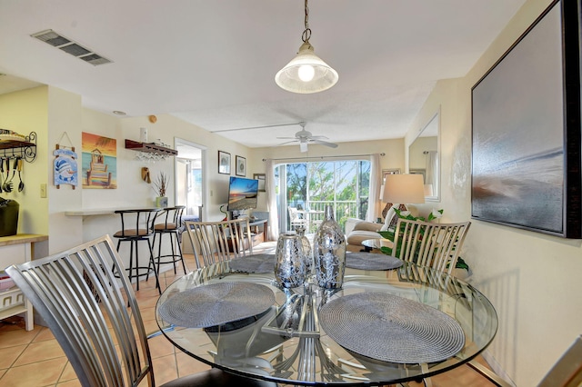 tiled dining space featuring ceiling fan