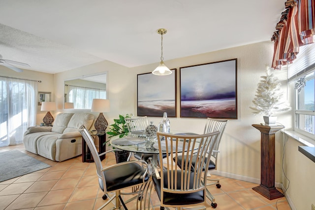 dining area with a wealth of natural light, light tile patterned flooring, a textured ceiling, and ceiling fan