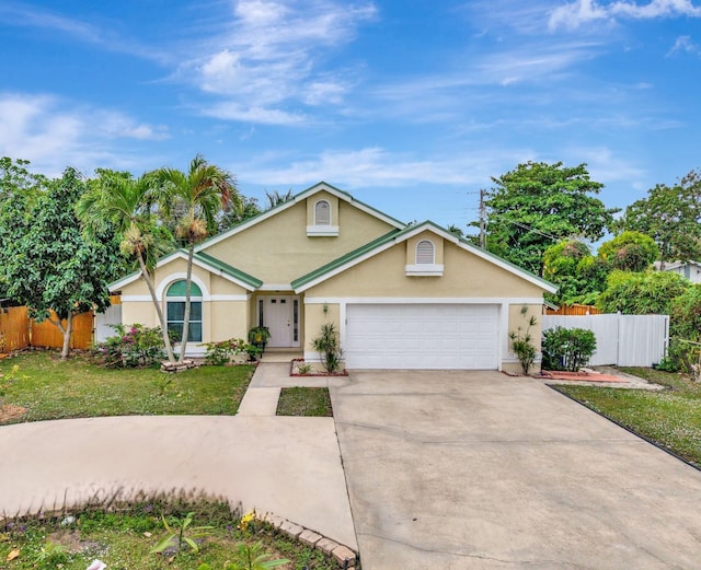 ranch-style home with a garage and a front yard