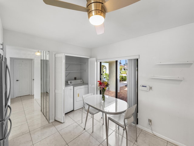 tiled dining space featuring washer and clothes dryer